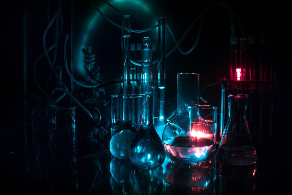 Dark chemistry laboratory with glowing glassware